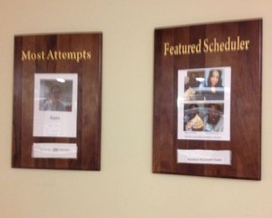 Two plaques on the wall that say most admired scheduler.