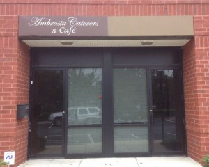 The entrance to a building with a sign that says adrian's cafe.