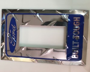 A chrome wall plate with the word ford rough on it.