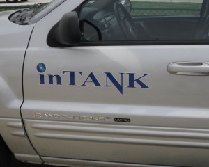 A white pickup truck with the word intank on it.