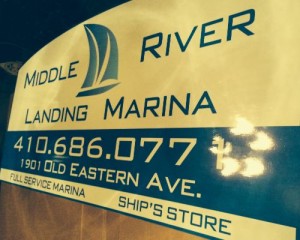 A sign that says middle river landing marina.