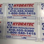 Sheet of multiple business cards for hydrotec, displaying company name, services, and contact information in blue and red text.