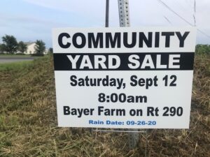 Sign advertising a community yard sale at bayer farm on route 290, scheduled for saturday, september 12 at 8:00 am, with a rain date of september 26, 2020.