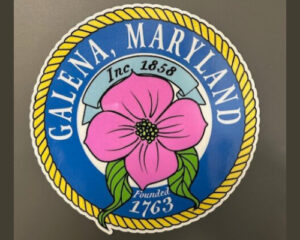Round logo of galena, maryland featuring a large pink flower, with the town's name and founding year (1763) and incorporation year (1858) displayed.